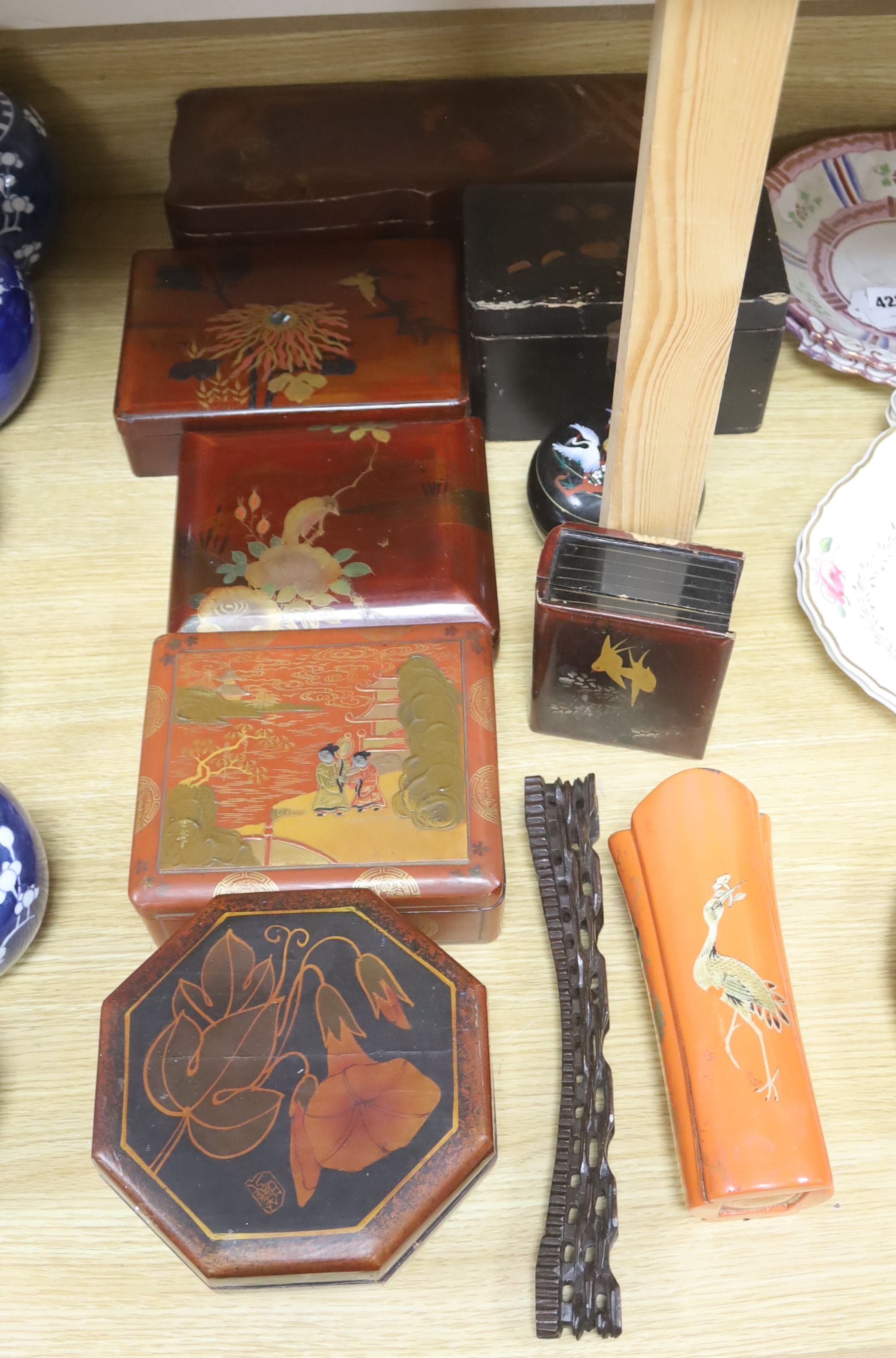 A group of Chinese or Japanese lacquer boxes and a wood stand